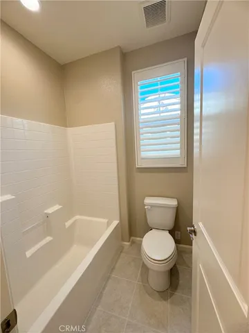 a bathroom with a toilet and a bathtub