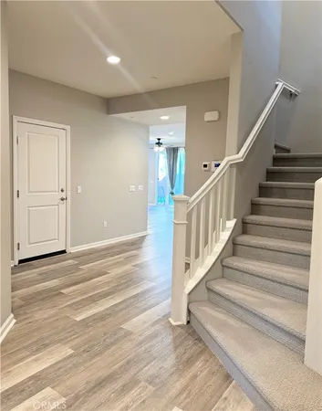 a view of entryway and hall with wooden floor