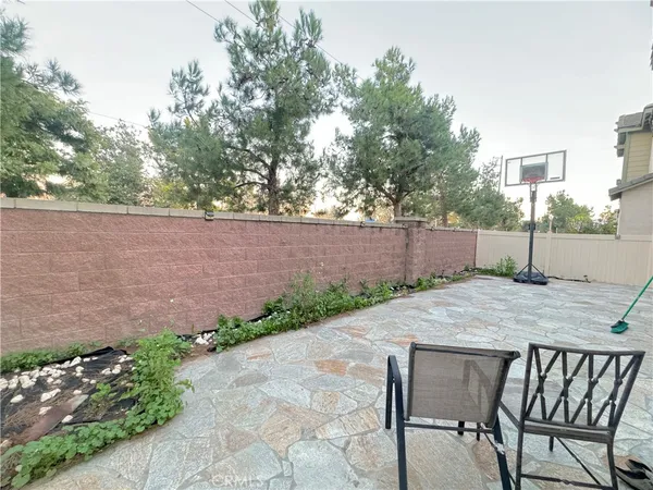 a backyard of a house with table and chairs