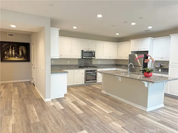 a kitchen with a sink cabinets and stainless steel appliances