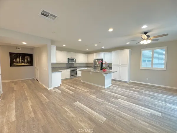 a view of kitchen with refrigerator sink and cabinets