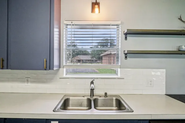a bathroom with a sink and a window