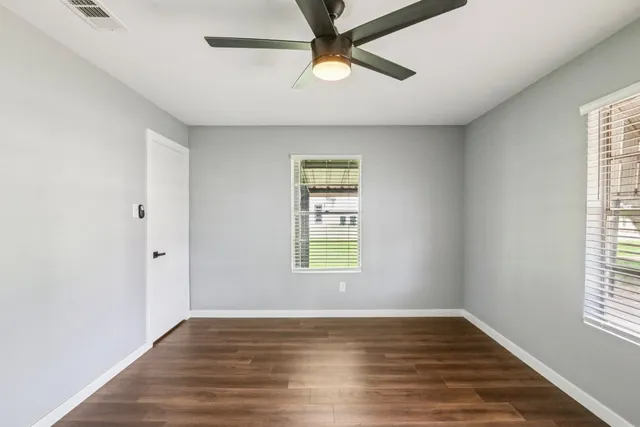 wooden floor in an empty room with a window