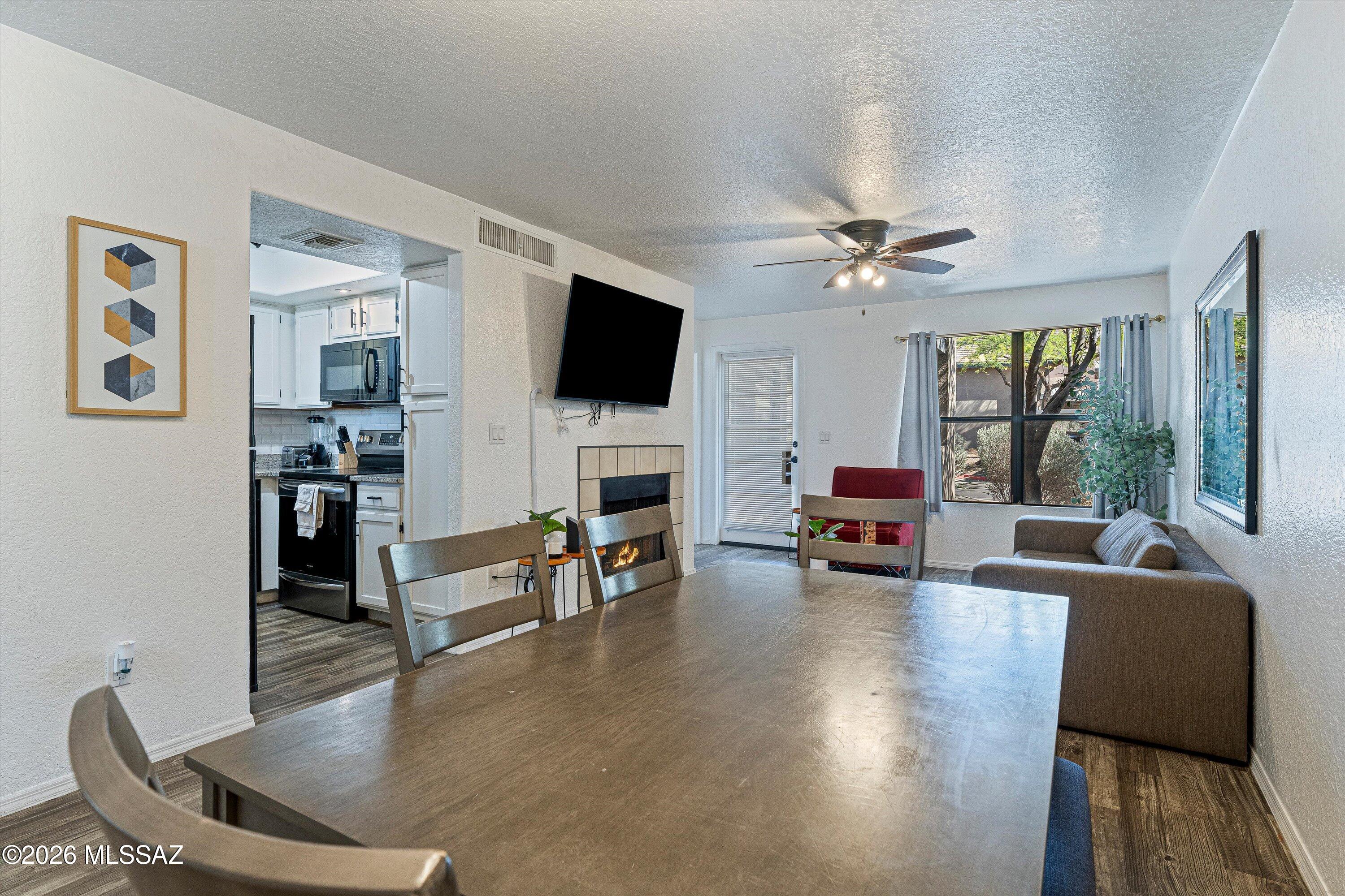 5800 North Kolb Road, Unit 1102 Tucson, AZ 85750 - Photo 6 of 36 a living room with furniture fireplace and a flat screen tv