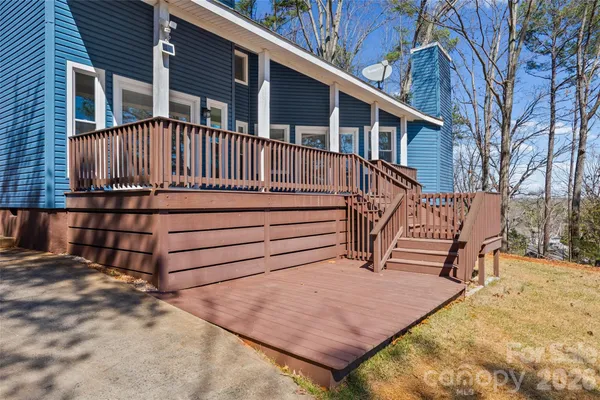 a view of a house with a wooden fence