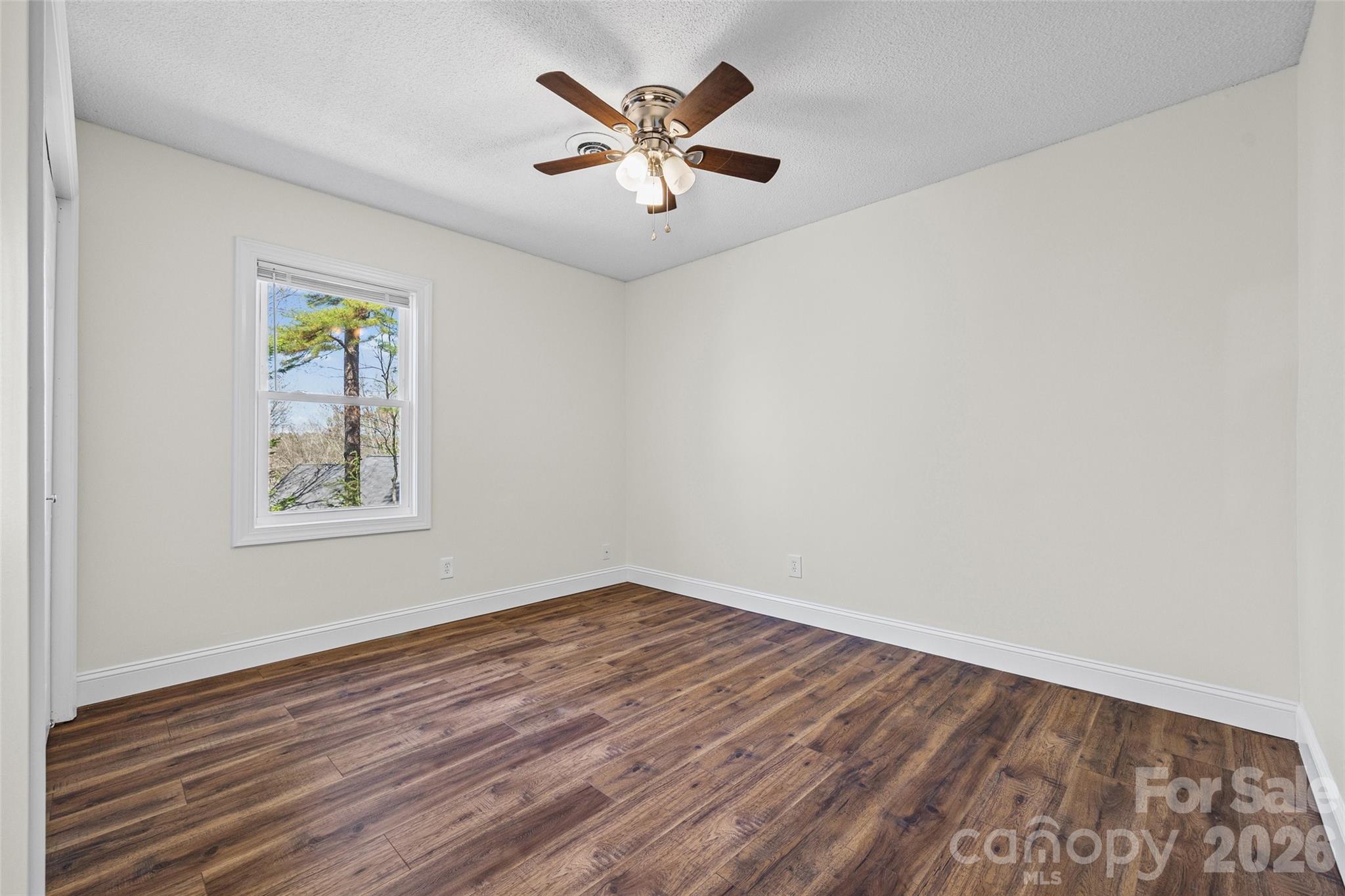 16149 Haroa Court Fort Mill, SC 29708 - Photo 16 of 40 an empty room with wooden floor and windows