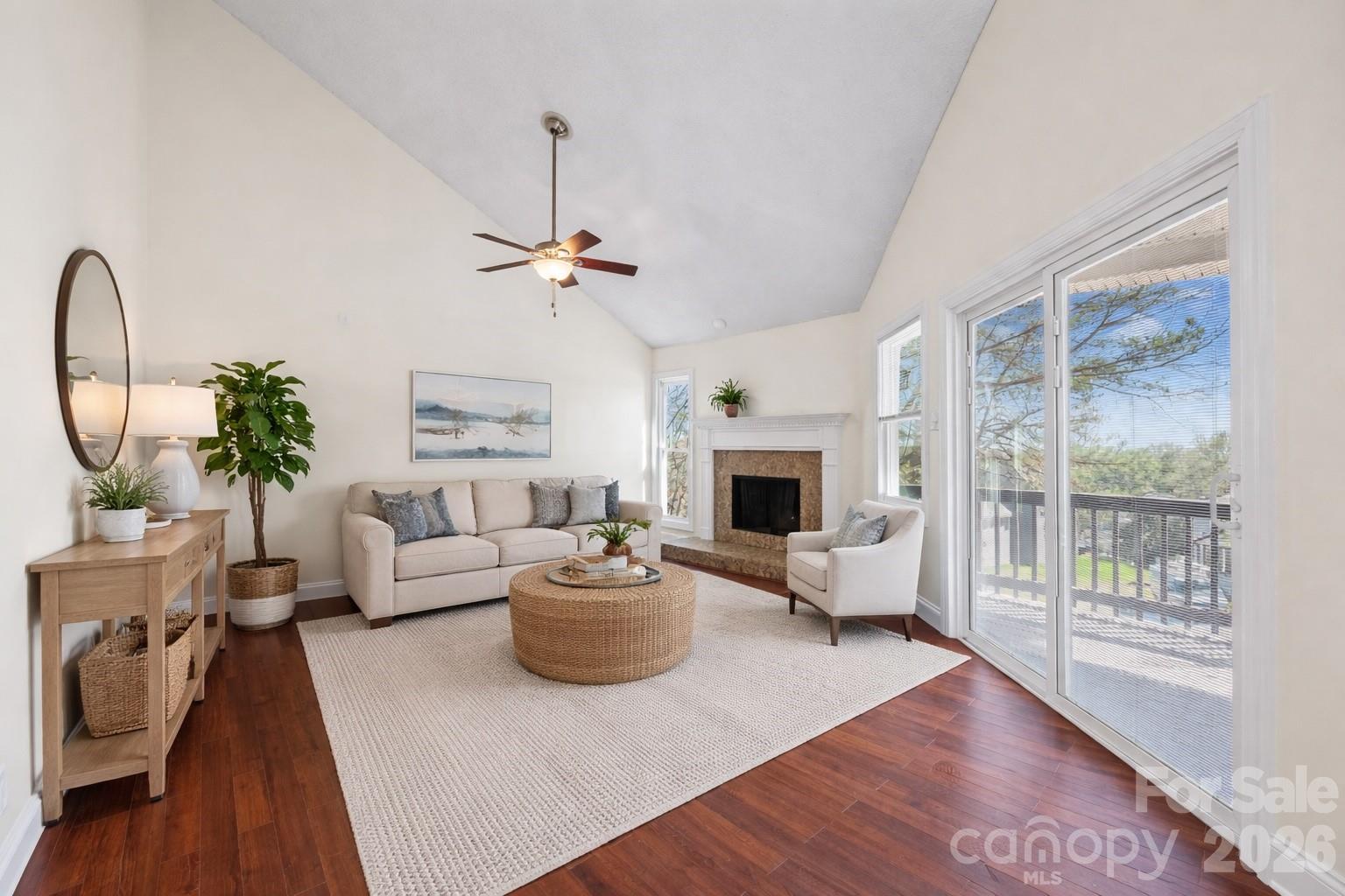 16149 Haroa Court Fort Mill, SC 29708 - Photo 5 of 40 a living room with furniture a fireplace and a floor to ceiling window