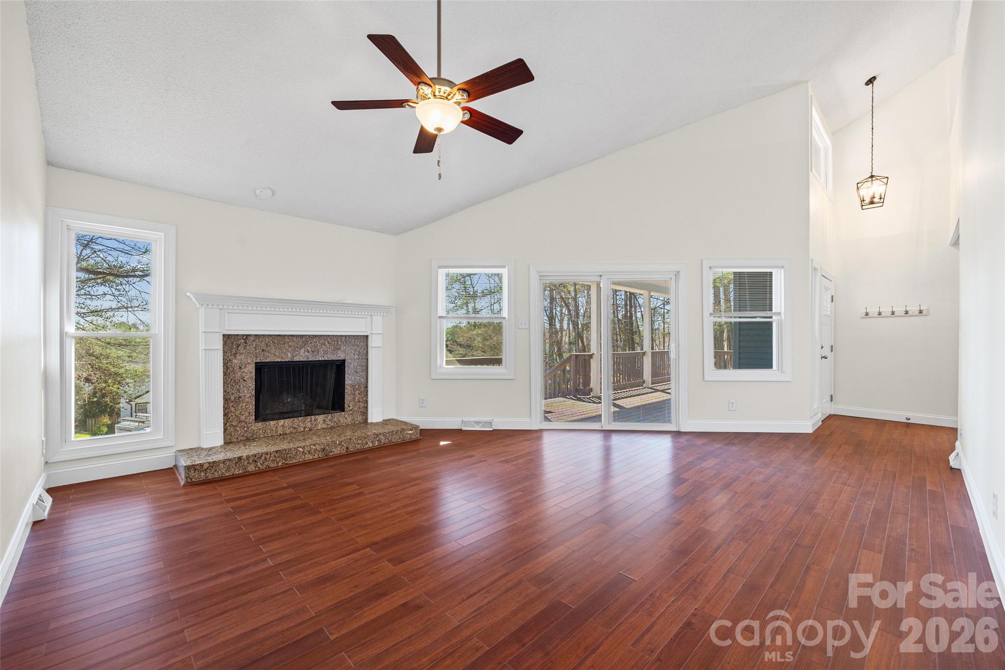 16149 Haroa Court Fort Mill, SC 29708 - Photo 7 of 40 an empty room with wooden floor a ceiling fan and windows