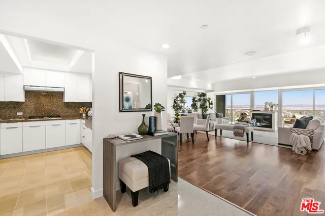 a living room with furniture and view of kitchen