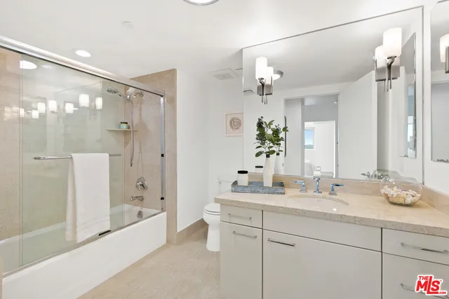 a bathroom with a double vanity sink mirror double and shower