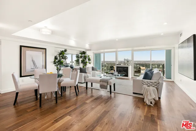 a living room with fireplace furniture and a wooden floor