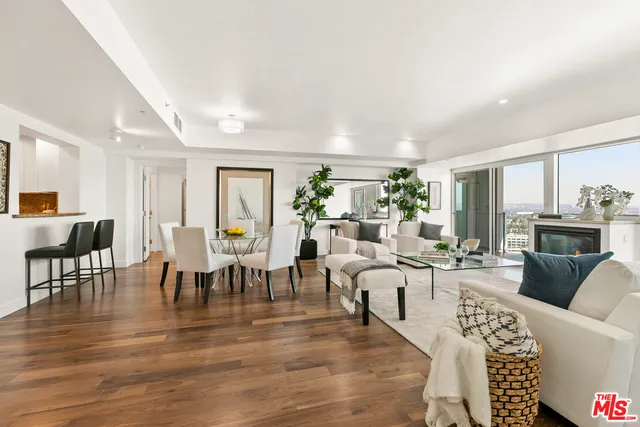 a living room with furniture dining table and a fireplace