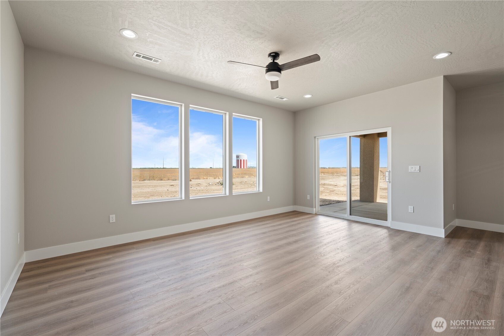 706 O Street Southwest Quincy, WA 98848 - Photo 10 of 33 a view of an empty room with wooden floor and a window