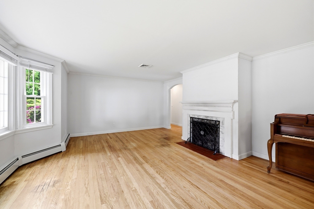 130 Connecticut Avenue Springfield, MA 01107 - Photo 26 of 40 a view of empty room with wooden floor and fireplace