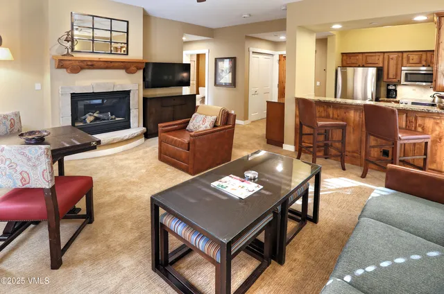 a living room with furniture a flat screen tv and a fireplace