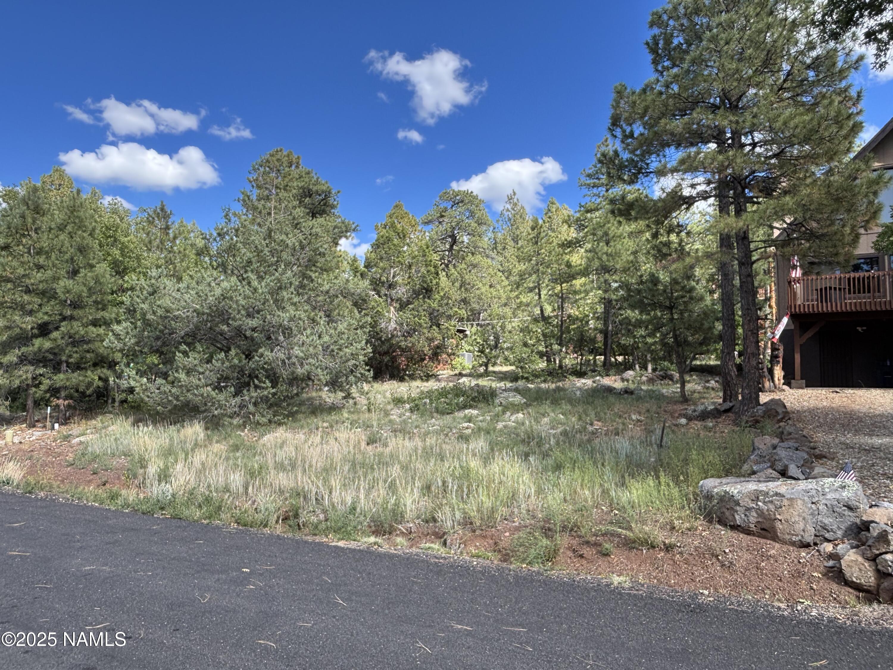 17615 Mustang Road Munds Park, AZ 86017 - Photo 4 of 4 a view of a lake with a yard