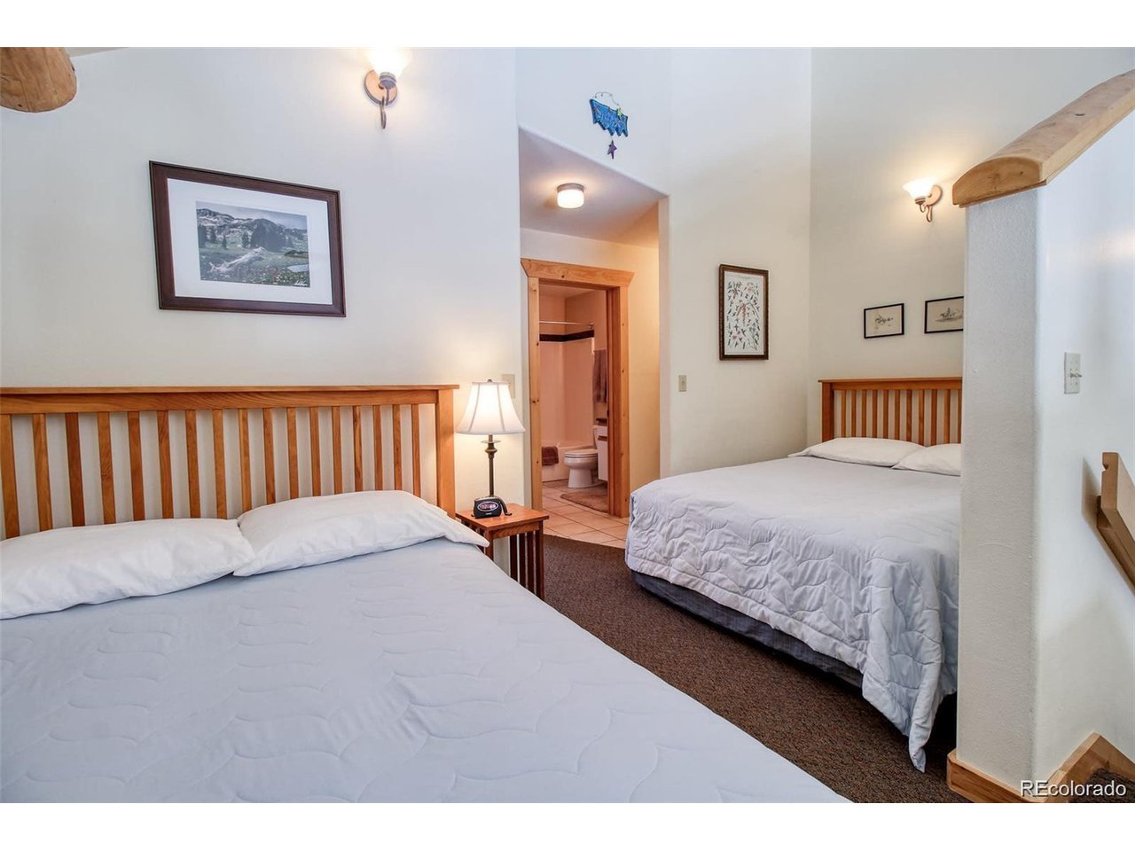 4 Lost Mine Loop, Unit 4B Leadville, CO 80461 - Photo 11 of 16 a bedroom with a large bed and a painting on the wall