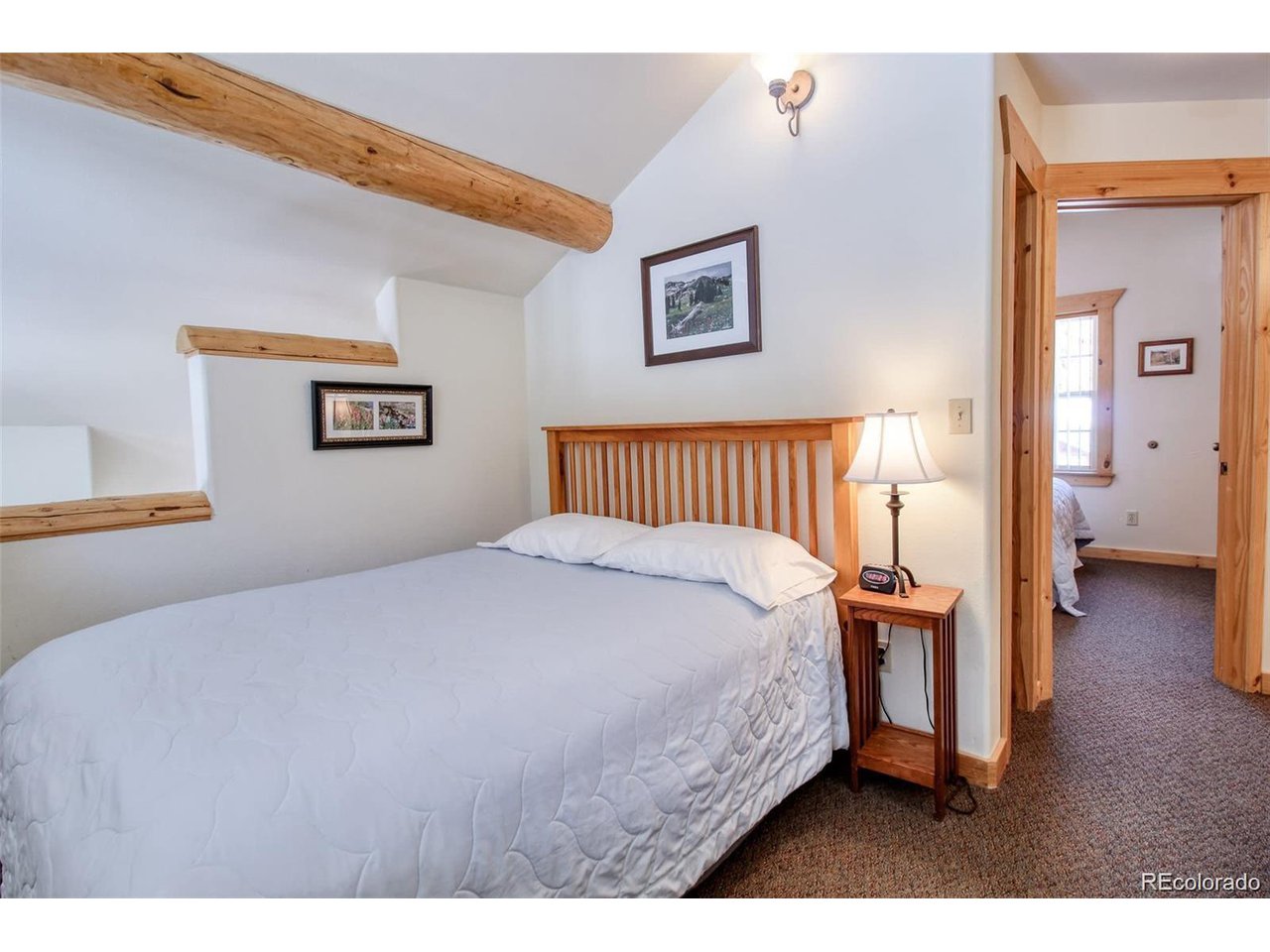 4 Lost Mine Loop, Unit 4B Leadville, CO 80461 - Photo 12 of 16 a bedroom with a bed and painting on the wall