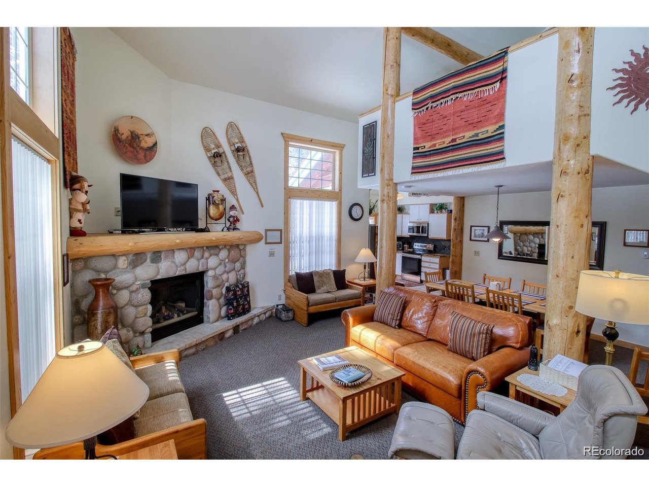4 Lost Mine Loop, Unit 4B Leadville, CO 80461 - Photo 2 of 16 a living room with furniture a fireplace and a flat screen tv