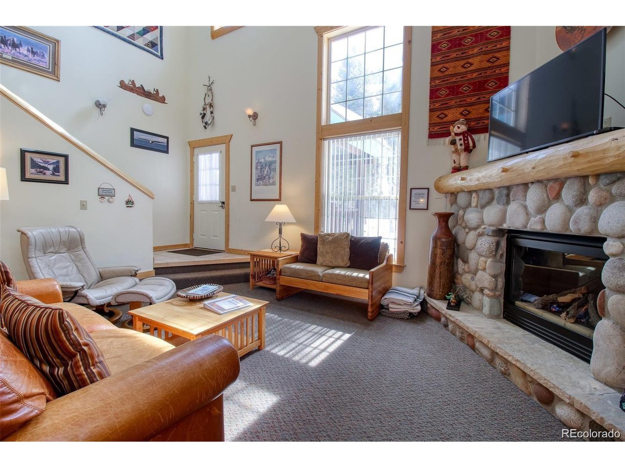 4 Lost Mine Loop, Unit 4B Leadville, CO 80461 - Photo 3 of 16 a living room with furniture a fireplace and a flat screen tv