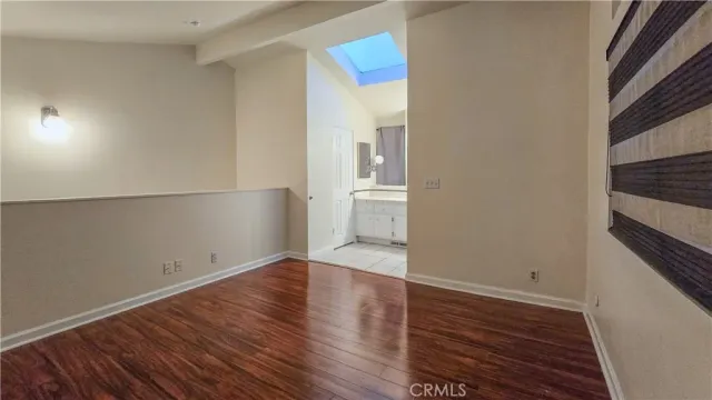 a view of a bathroom with wooden floor and sink