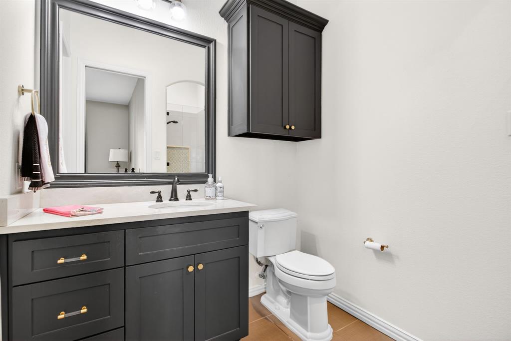 301 Rustic View Lane Aledo, TX 76008 - Photo 24 of 40 a bathroom with a toilet a sink a vanity and mirror