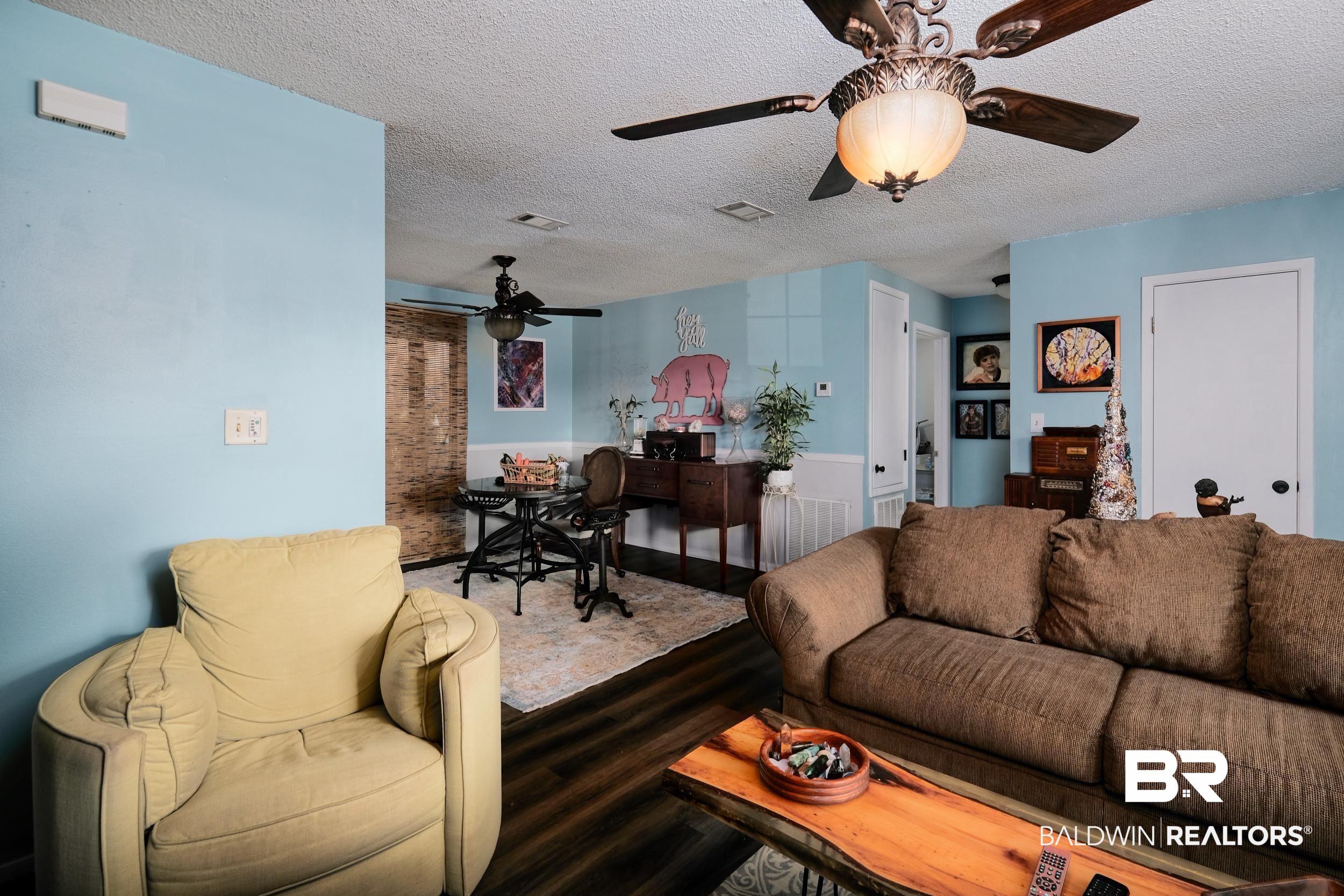 504 Ariel Avenue Foley, AL 36535 - Photo 14 of 33 Living room featuring hardwood / wood-style flooring, a textured ceiling, and ceiling fan