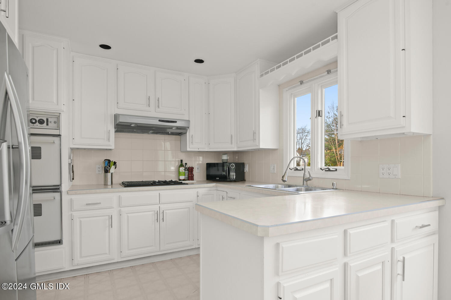 38 Amherst Road Riverside, CT 06878 - Photo 4 of 22 a kitchen with stainless steel appliances granite countertop a sink and cabinets