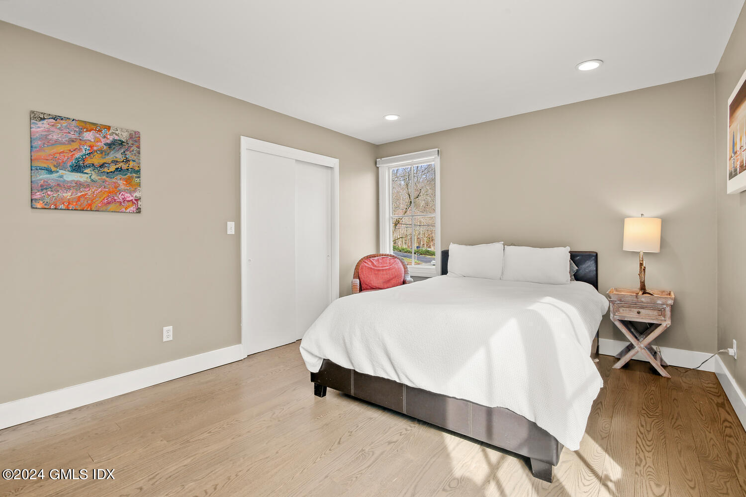 38 Amherst Road Riverside, CT 06878 - Photo 9 of 22 a bedroom with a bed and a painting on the wall