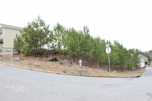 a view of road with parked cars