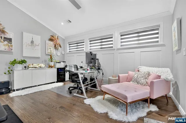 a living room with furniture a dining table and a window