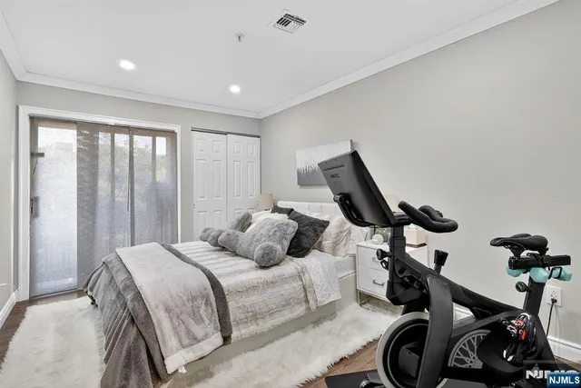 a bedroom with a bed and a view of living room