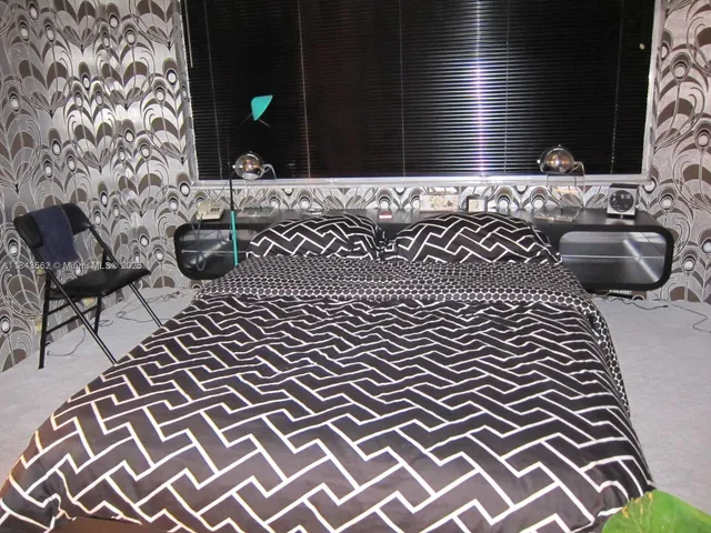 a view of a balcony with chairs and a potted plant