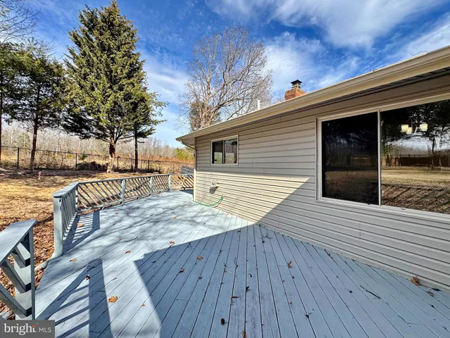 a view of a wooden bench next to a house