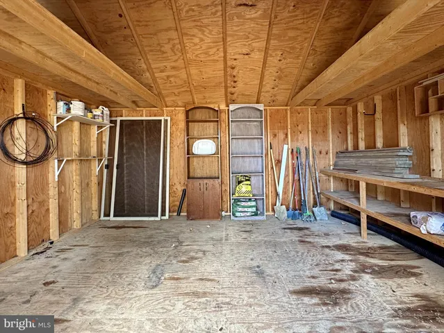 a living room with stainless steel appliances wooden floor and fireplace