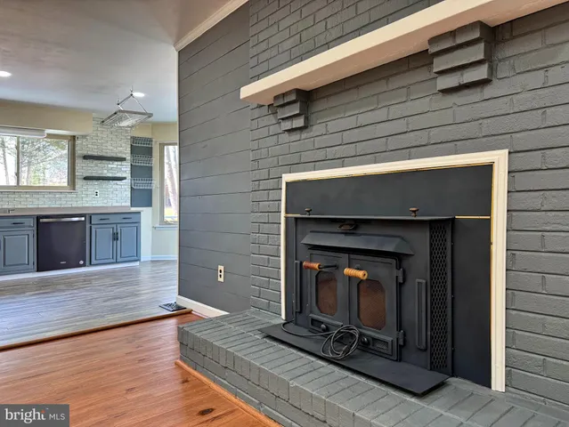 an empty room with windows and ceiling fan
