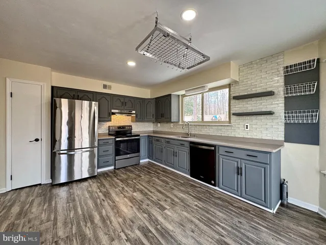 a spacious bathroom with a double vanity sink and a mirror
