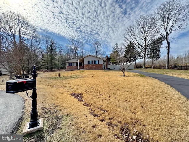 a view of a house with trees in the background