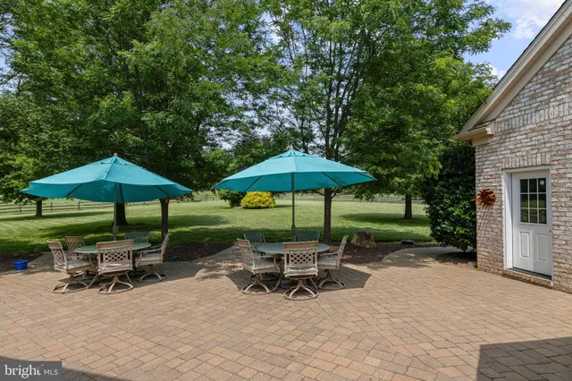 a bathroom with a granite countertop sink toilet a mirror a vanity and shower