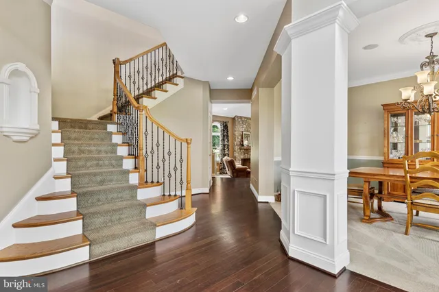 a living room with furniture a fireplace and a floor to ceiling window