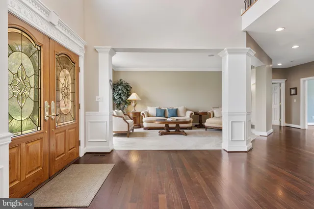 a living room with furniture large window and a fireplace