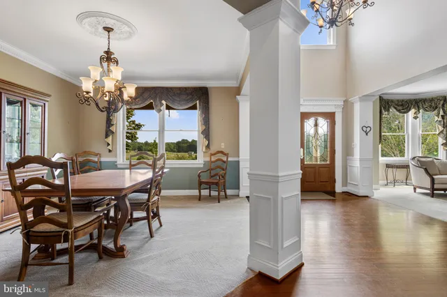a view of backyard with seating space and wooden fence