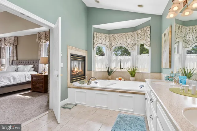 a kitchen with stainless steel appliances granite countertop table chairs sink and cabinets