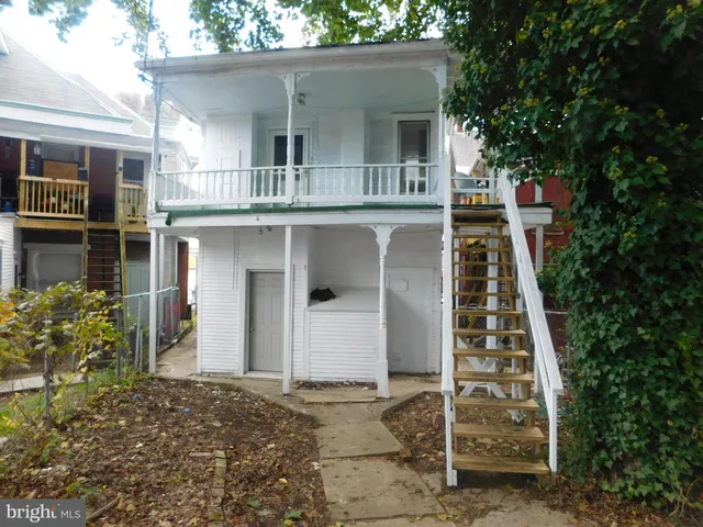a kitchen with a sink stove top oven and refrigerator