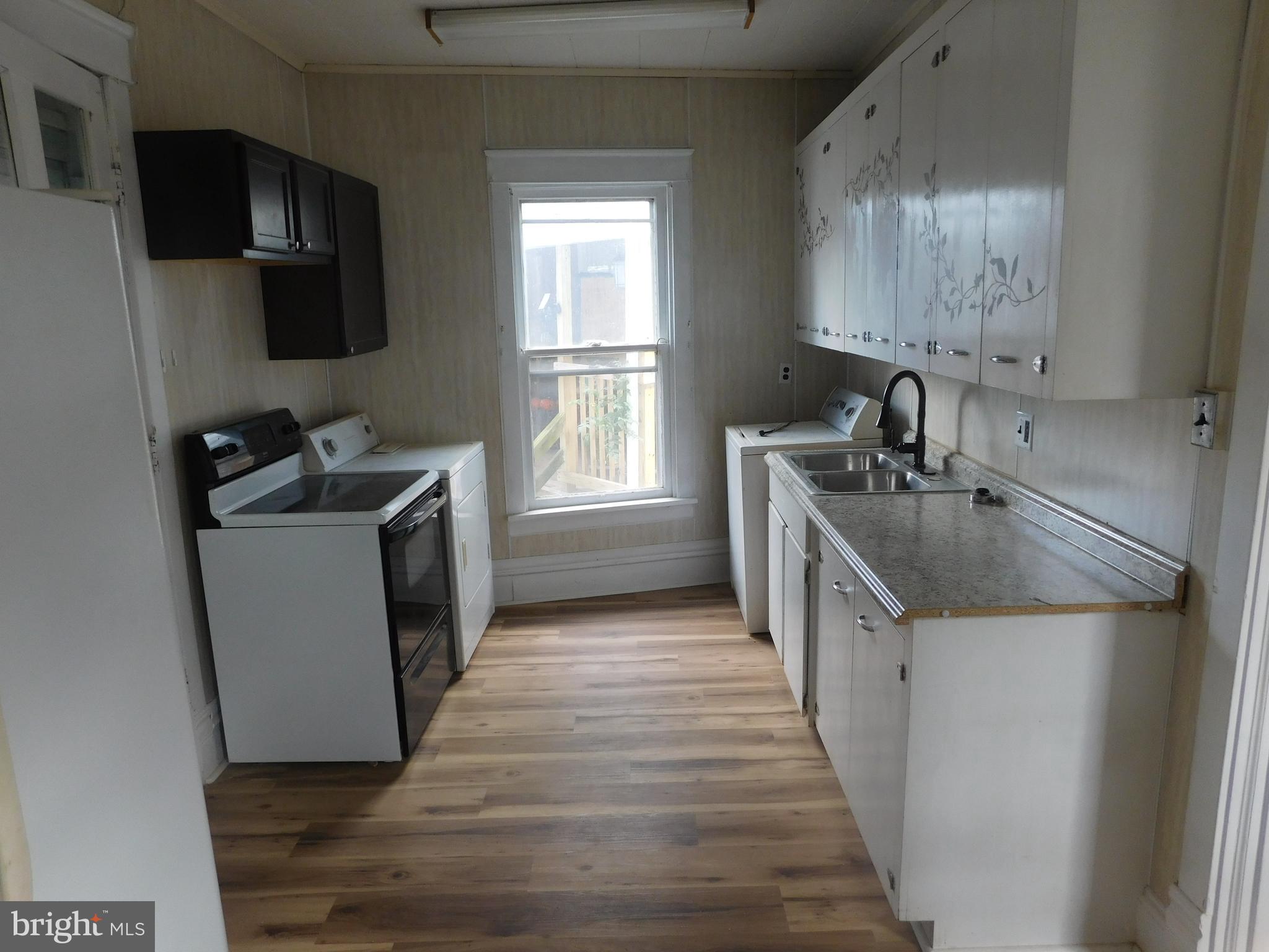 247 East 3rd Street Lewistown, PA 17044 - Photo 13 of 24 a kitchen with a sink stove top oven and refrigerator