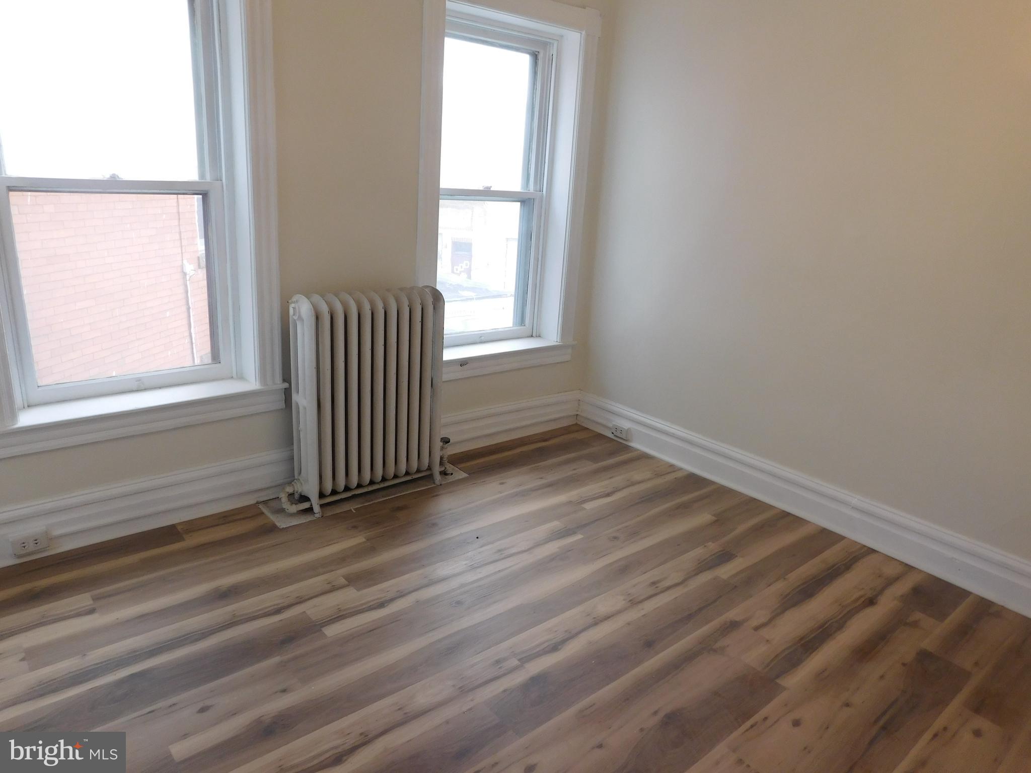 247 East 3rd Street Lewistown, PA 17044 - Photo 15 of 24 an empty room with wooden floor and windows