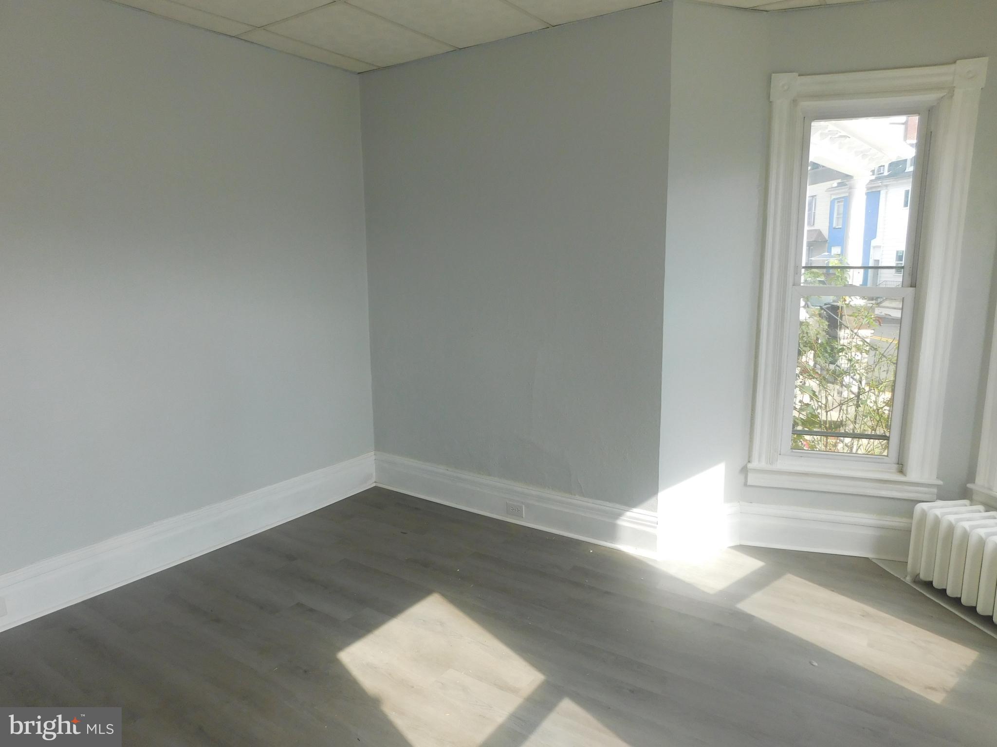 247 East 3rd Street Lewistown, PA 17044 - Photo 2 of 24 an empty room with wooden floor and windows