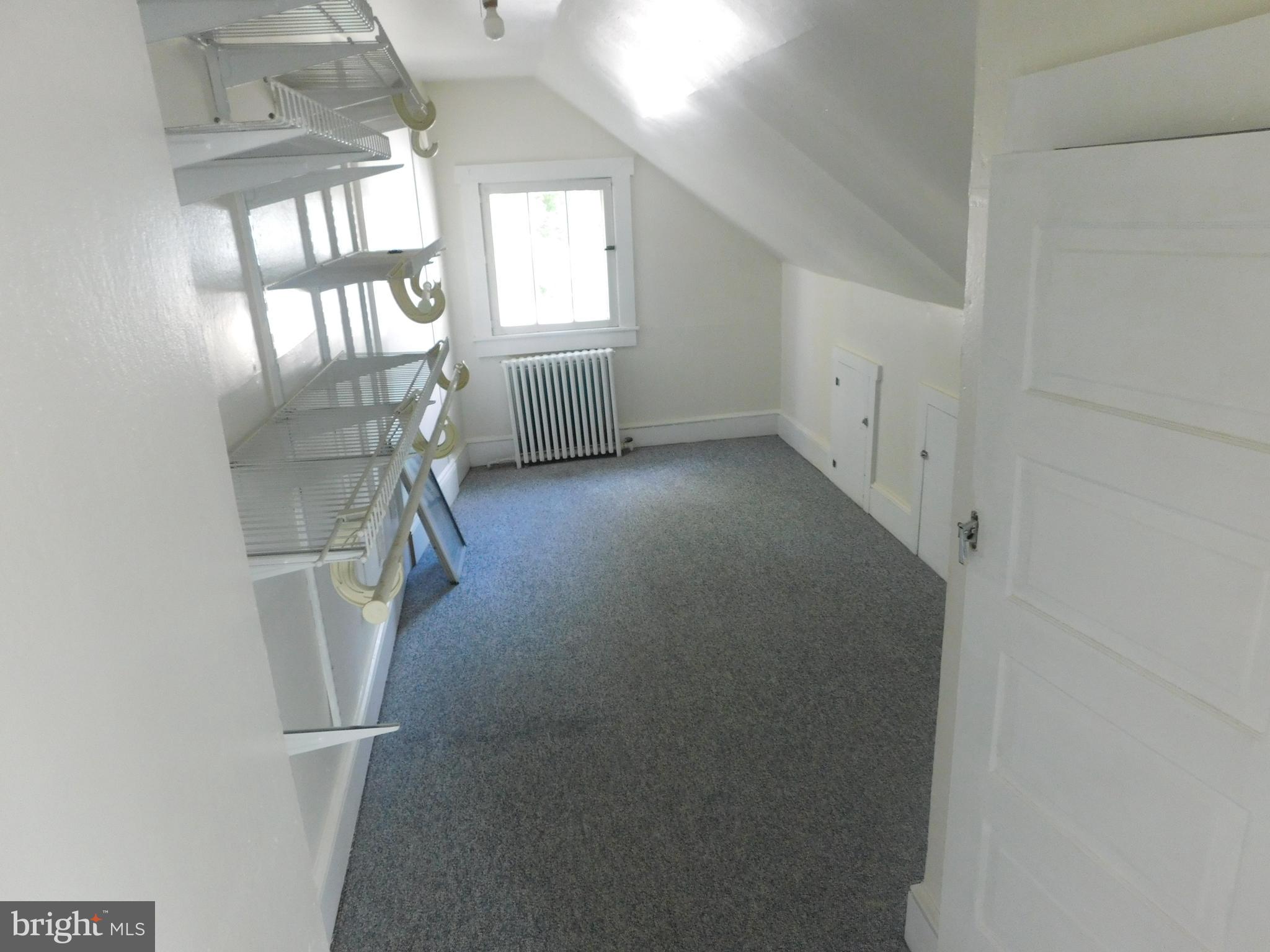 247 East 3rd Street Lewistown, PA 17044 - Photo 21 of 24 an empty room with a fireplace and windows