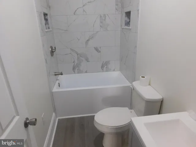 a bathroom with a sink a toilet and bathtub