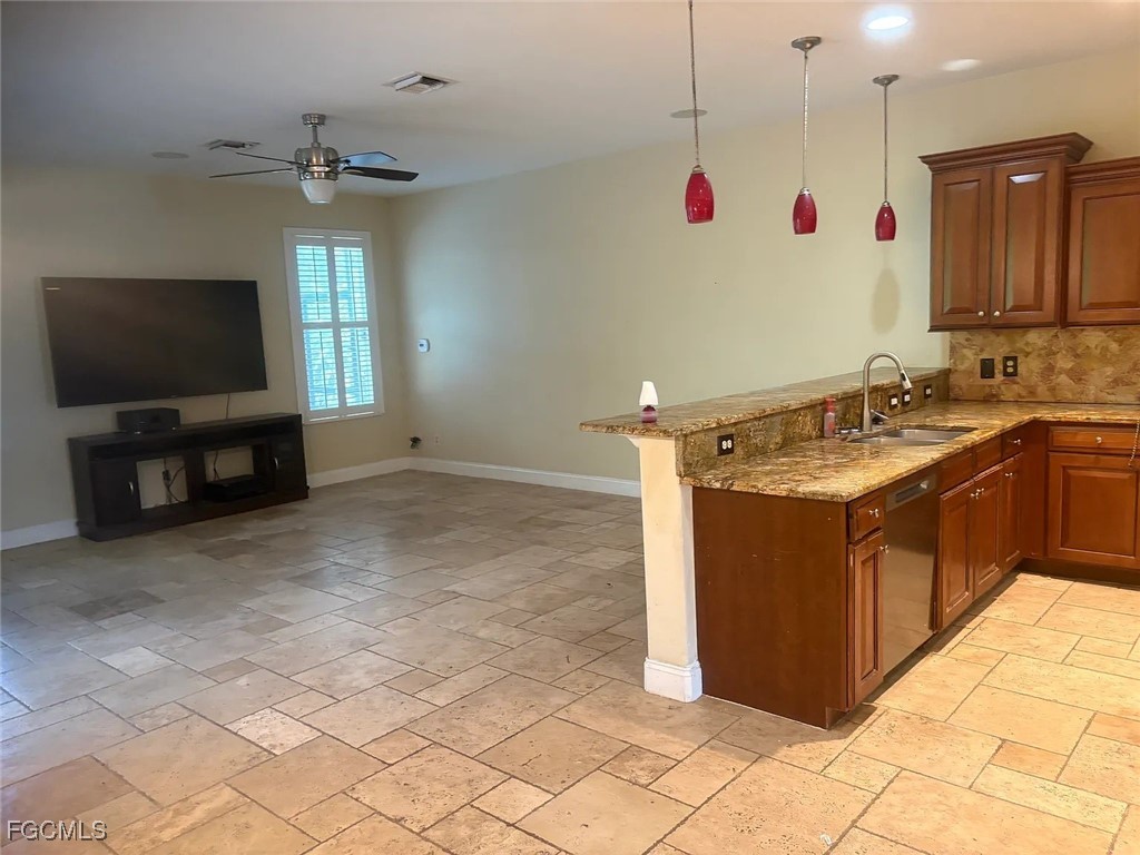 12398 Rock Ridge Lane Fort Myers, FL 33913 - Photo 15 of 43 a kitchen with kitchen island granite countertop a sink and a stove top oven with wooden floor